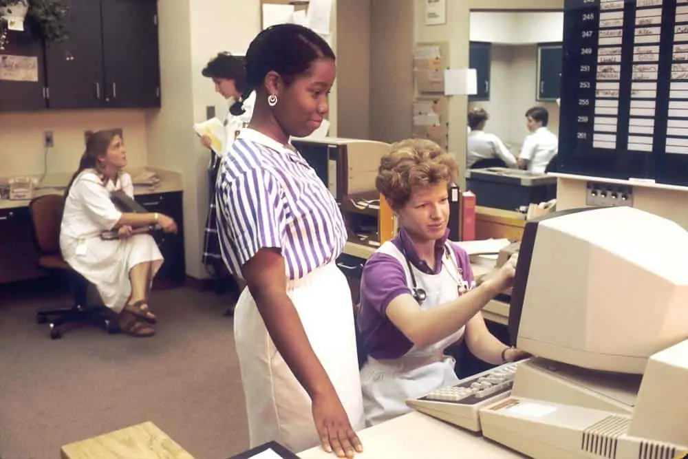 A medical office in the 1980s when computers started to replace typewriters.