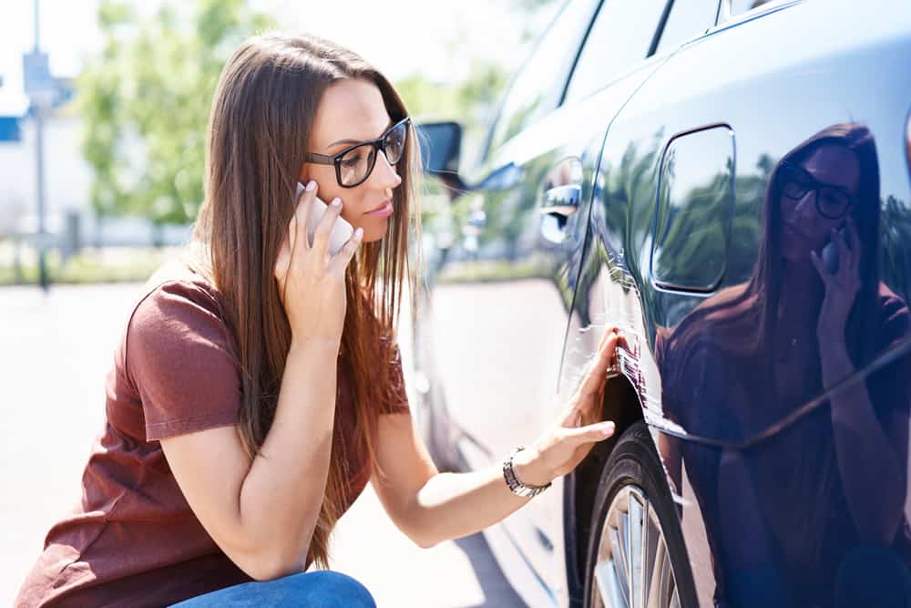 Claims adjuster dictating notes into a cellphone to record notes faster.