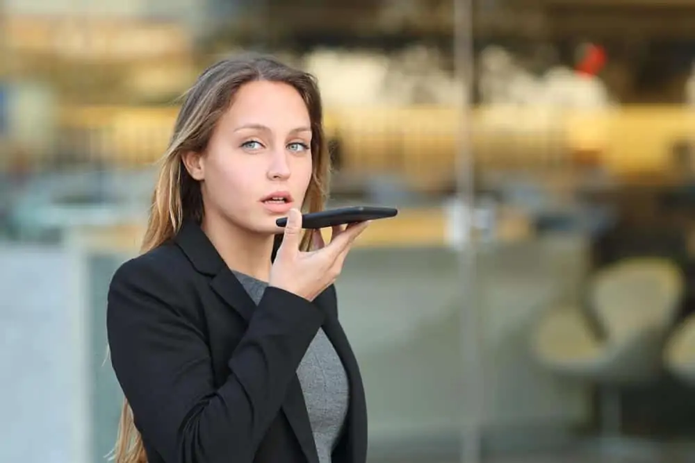 Busy attorney dictating notes as she walks to a client meeting.