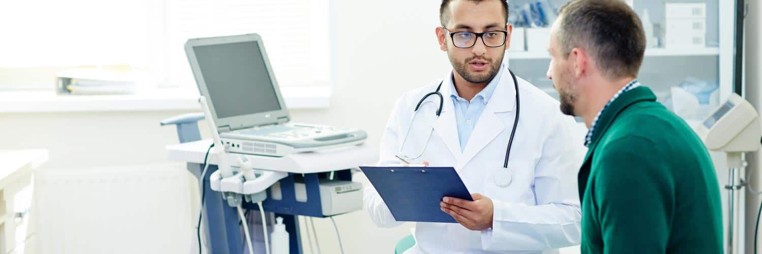 Doctor with a patient. Clinicial documention improvement (CDI) improves patient record quality and reduces errors.