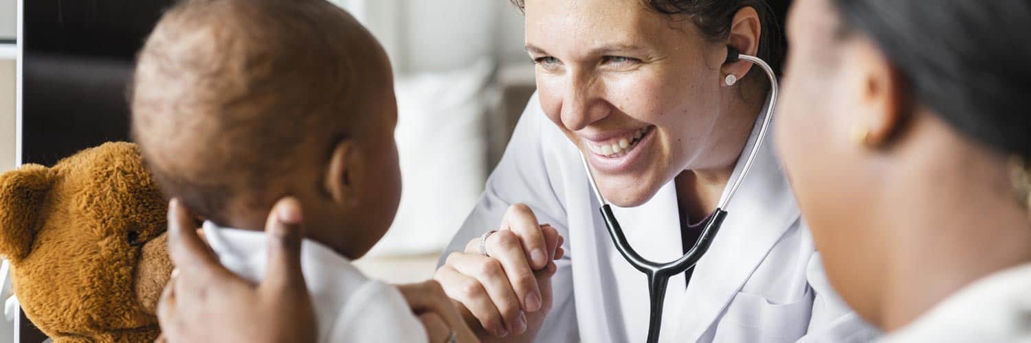 Doctor ignoring her computer and focusing instead on the patient.