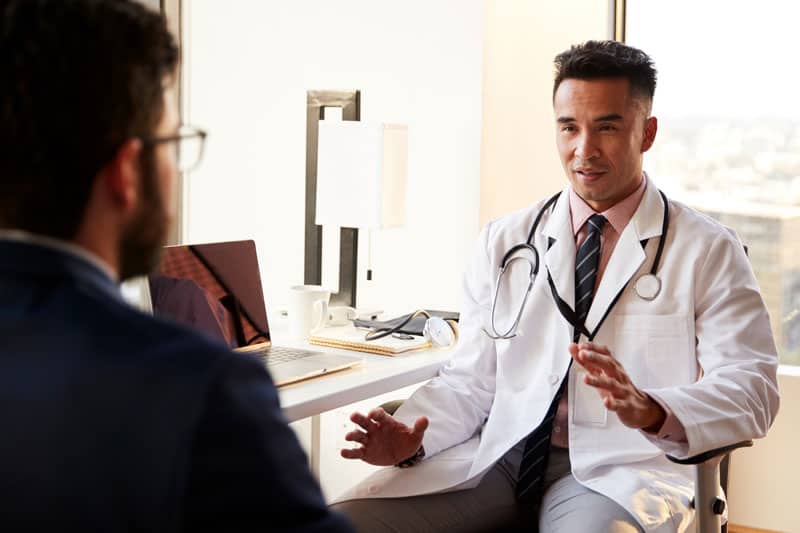 Physician adding some things to his EMR and recording notes for longer notes.