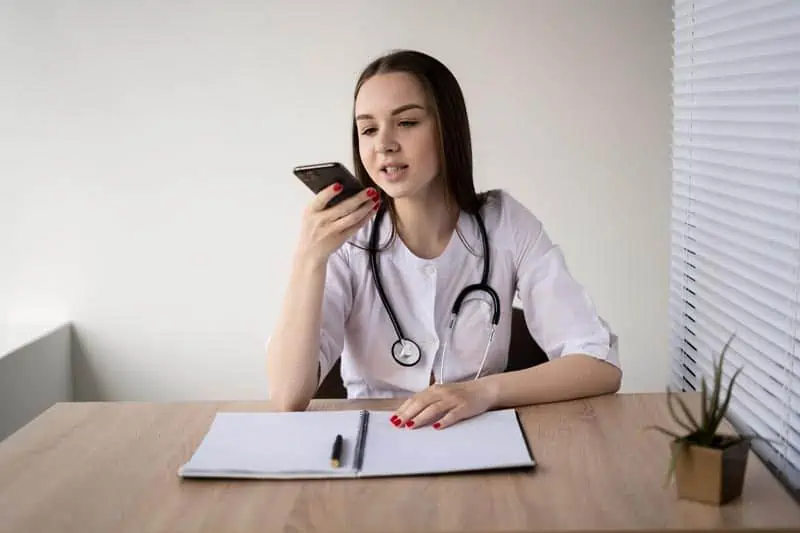 Doctor dictating notes instead of typing into a complex EMR system.