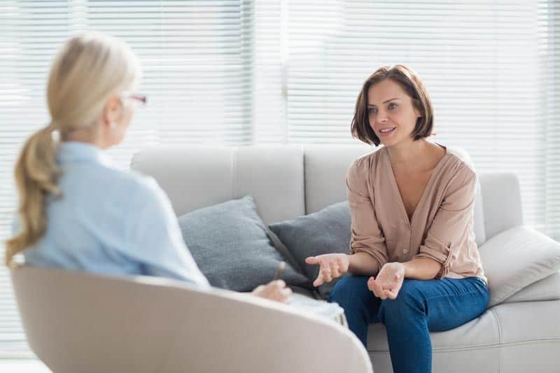 Psychologist talking one on one with a client. Psychology transcription services help increase face-to-face conversation.