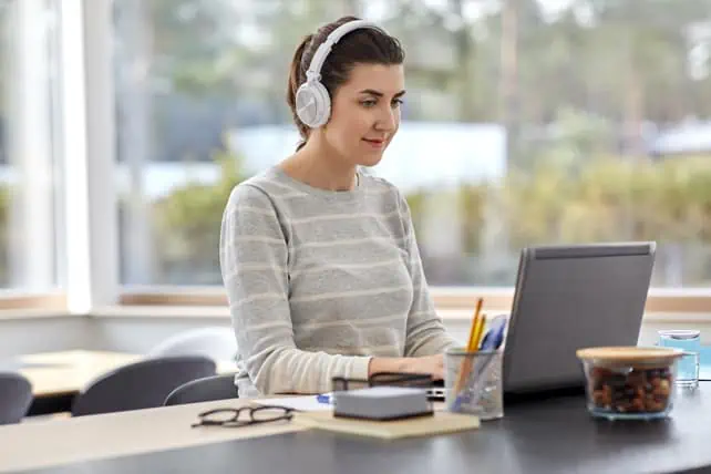 Transcriptionist typing with headphones. Professional Transcription Services, Inc. is now part of iMedat.